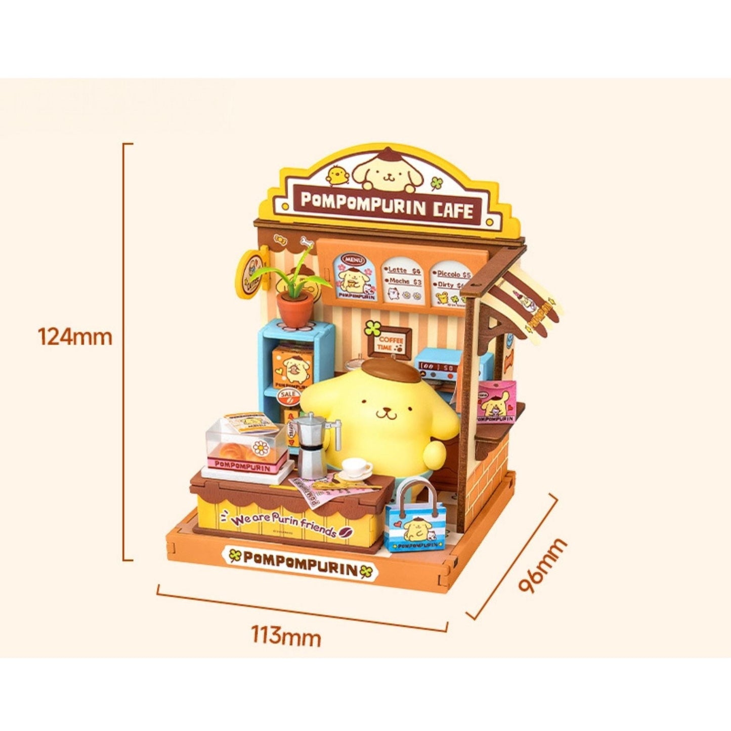 A miniature model of a Pompurin Cafe, featuring a yellow pom-pom character sitting at a counter with various items such as a coffee machine, a cake, and a handbag.