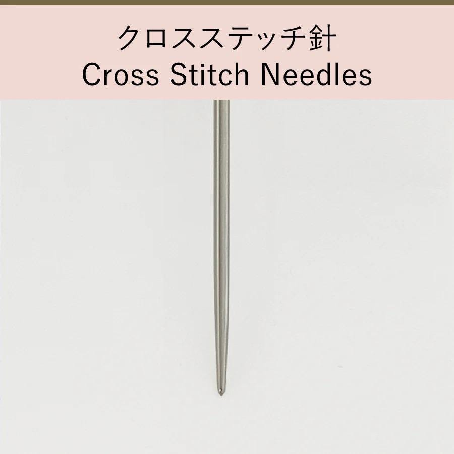 a single cross-stitch needle against a white background.