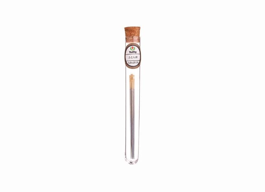 A clear glass tube containing a single object, which appears to be a small metal object, possibly a piece of jewelry or a decorative item.