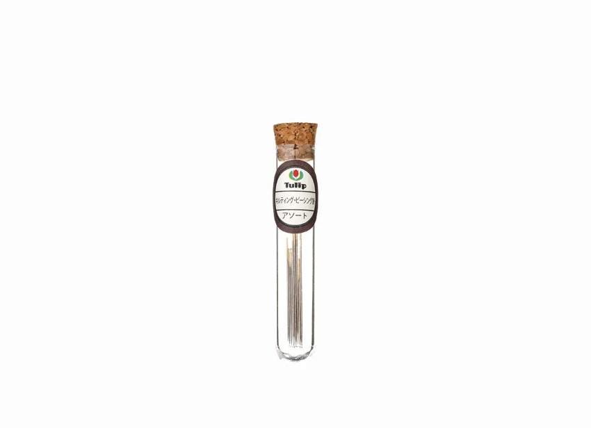 A clear glass tube with a cork stopper, containing a small amount of what appears to be a liquid or powder.