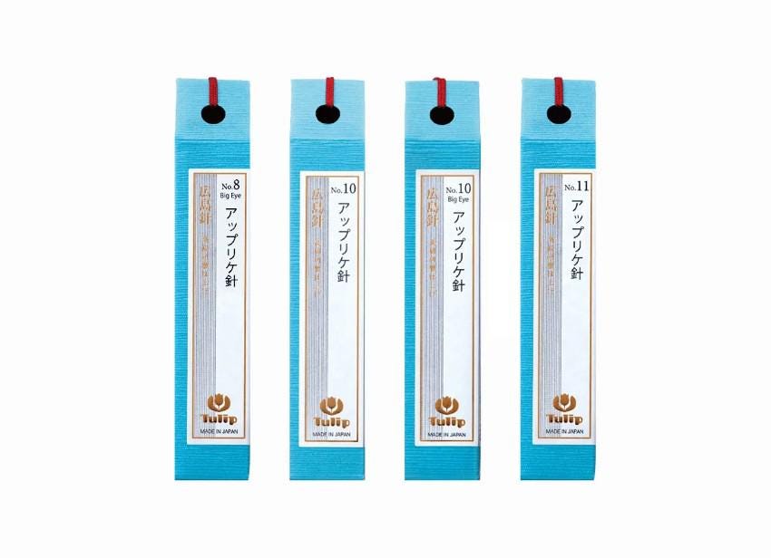 four blue pencils with red bindings, each labeled with Japanese text.