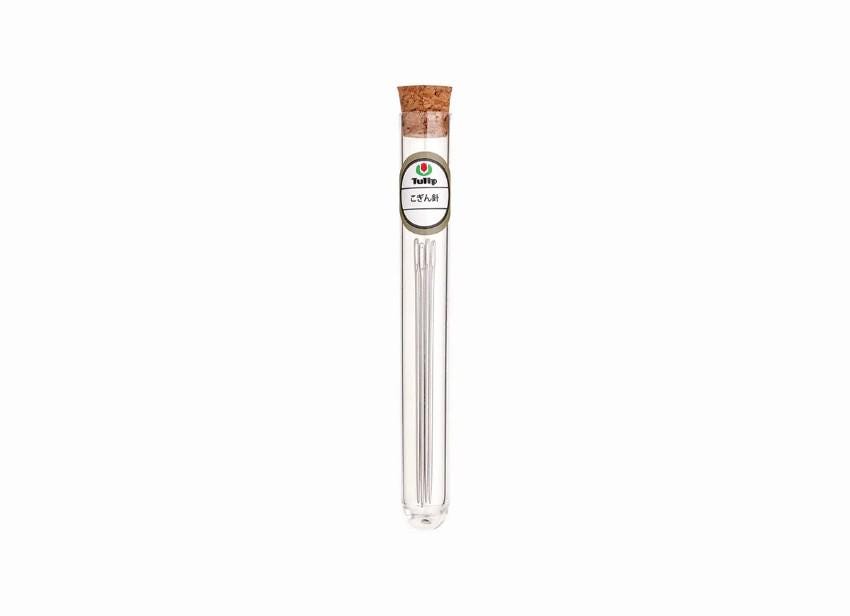 A clear glass tube with a cork stopper, containing a small amount of what appears to be a liquid or powder.