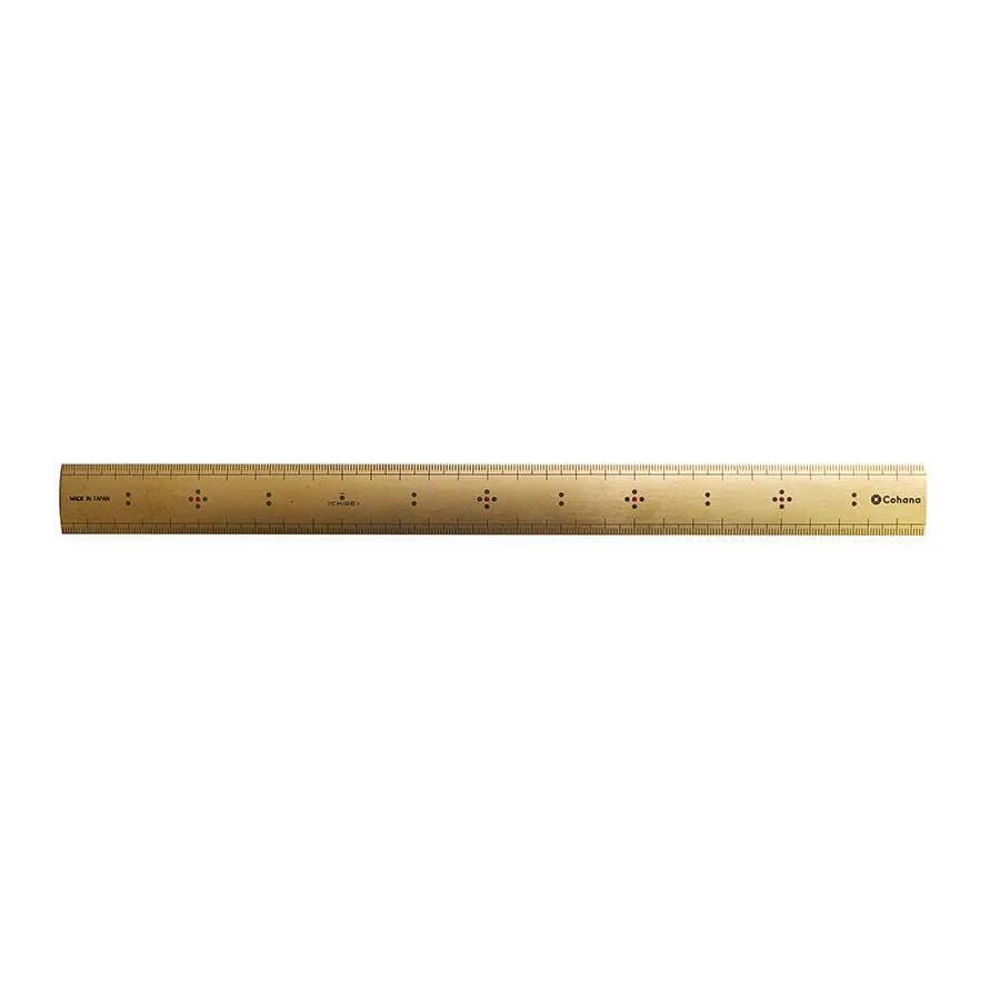 a gold-colored ruler with black markings on a white background.