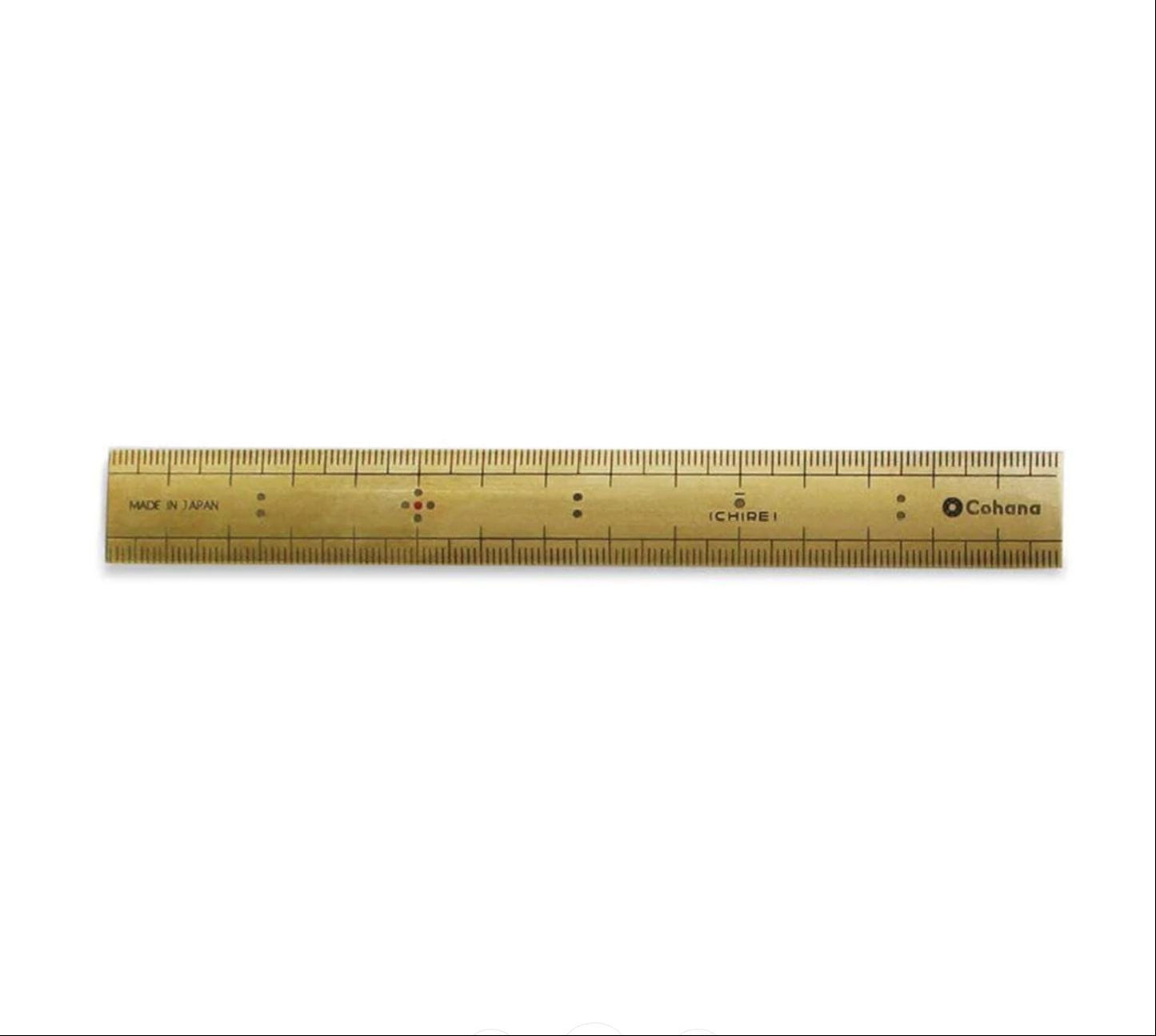 A gold-colored ruler with black markings and text, including the brand name "Cohana".