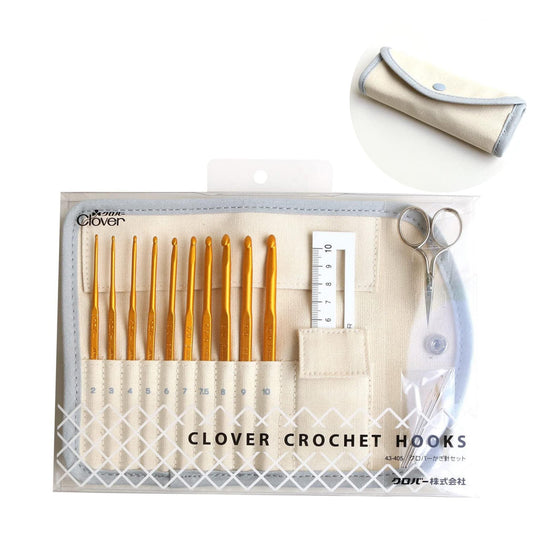 A set of crochet hooks and a measuring tape in a clear plastic case with a beige and white color scheme.