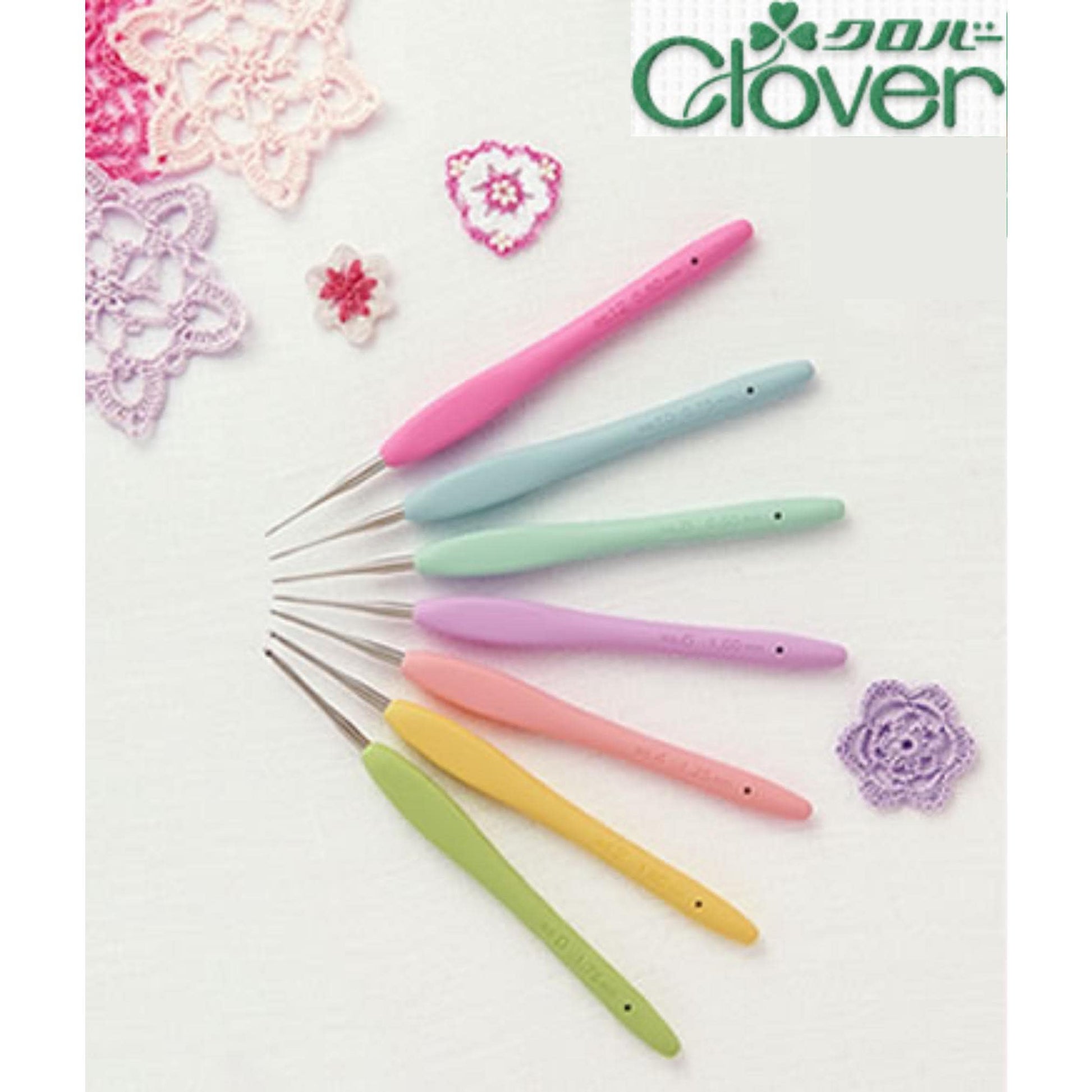 A collection of crochet hooks in various pastel colors, including pink, blue, green, and yellow, arranged on a white background.