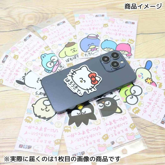 A smartphone with a Hello Kitty sticker is surrounded by various other stickers and cards featuring cartoon characters.