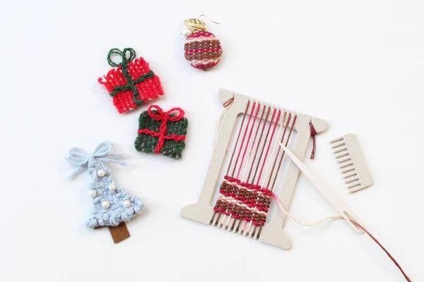 various craft items, including a Christmas tree ornament, a gift box, and a weaving loom, arranged on a white background.