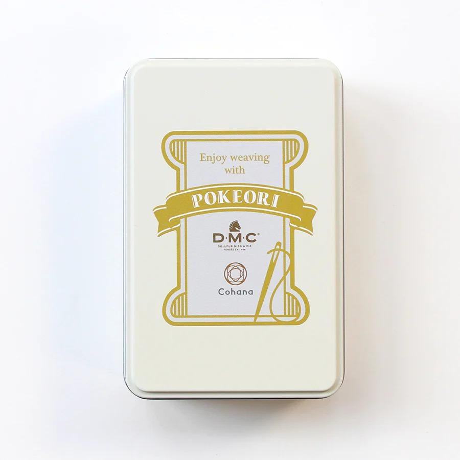 a white rectangular box with a gold and white label that reads "Enjoy weaving with POKERI" and "DMC" along with a logo.