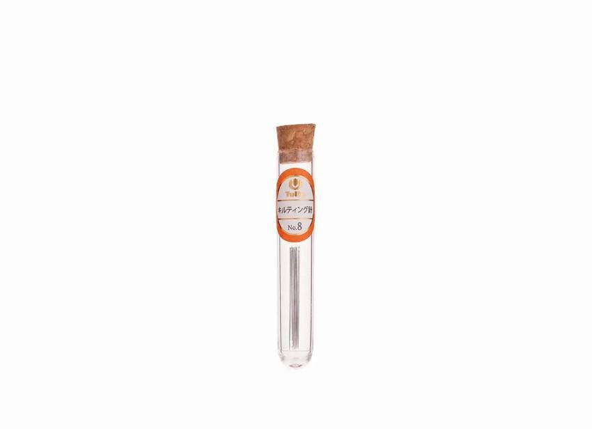 A clear glass tube with a cork stopper, containing a small object, is shown against a white background.