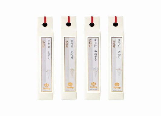 four identical white boxes with red handles, each containing a small yellow umbrella.
