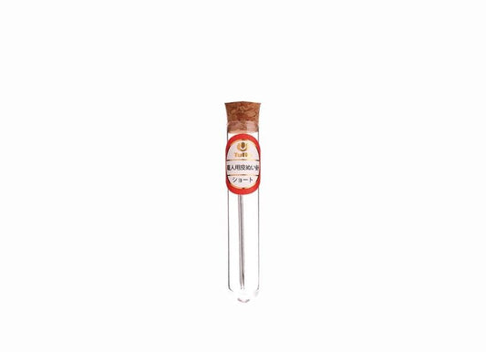 A clear glass tube with a cork stopper and a red label with white text.