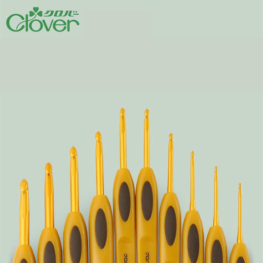 A collection of yellow crochet hooks arranged in a row against a light green background.