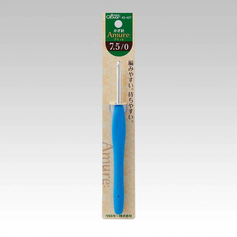 A blue crochet hook with a green and white label on a package.