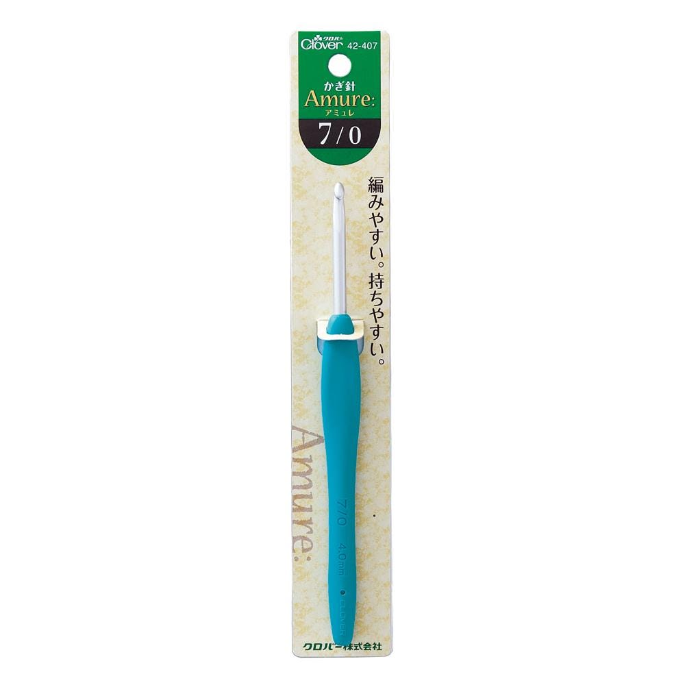 A blue crochet hook with a green and white label on a package.