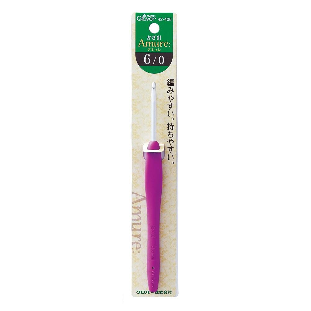 A purple crochet hook with a green and white label on a package.