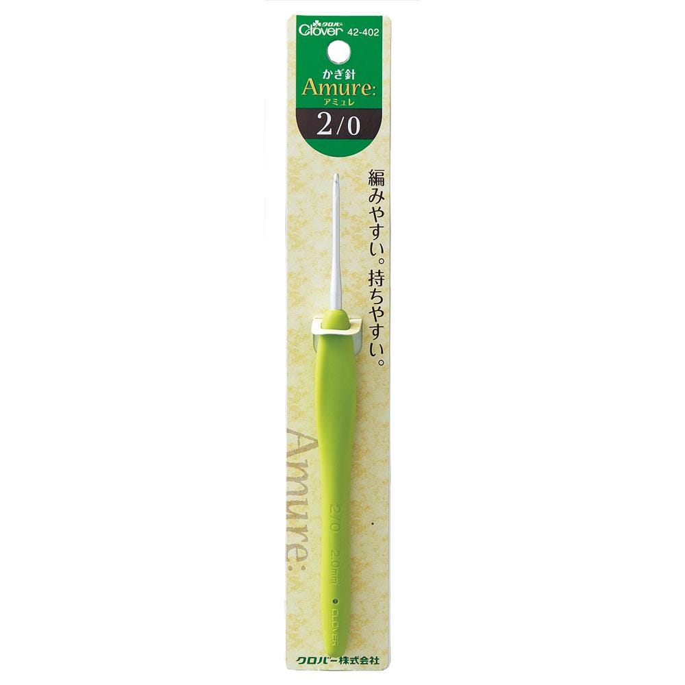 A green crochet hook with a yellow and green label on a package.