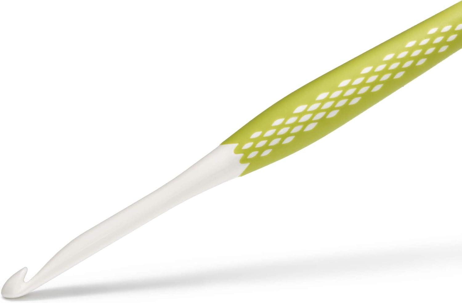 A crochet hook with a white and green color scheme.