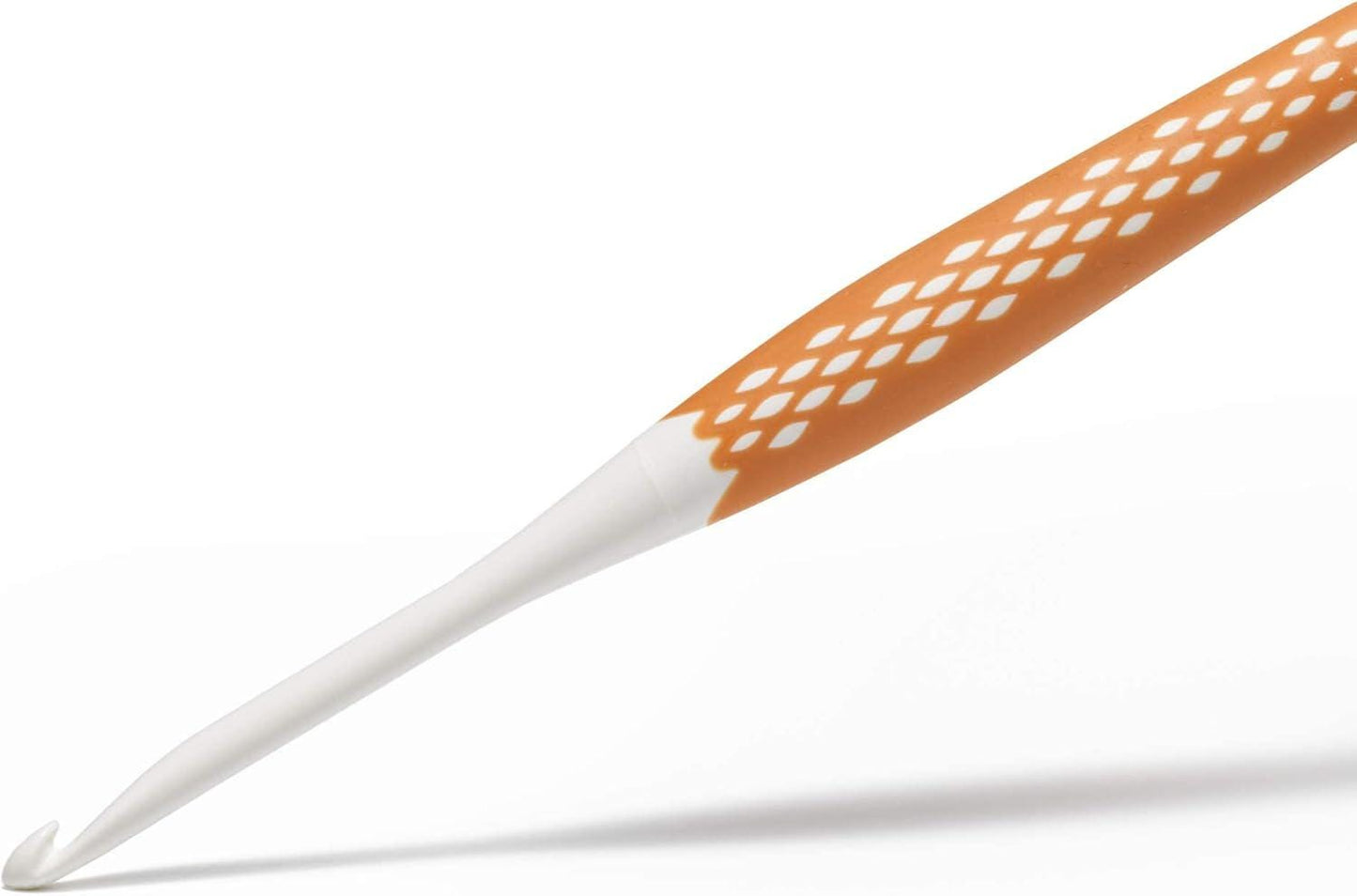 a crochet hook with a white and orange color scheme, featuring a pattern of small white diamonds on the handle.
