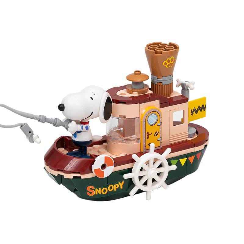 A toy boat with a cartoon character on it, resembling the character Snoopy from the Peanuts comic strip.