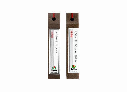 two identical brown boxes with red handles, each containing Japanese text and a logo.