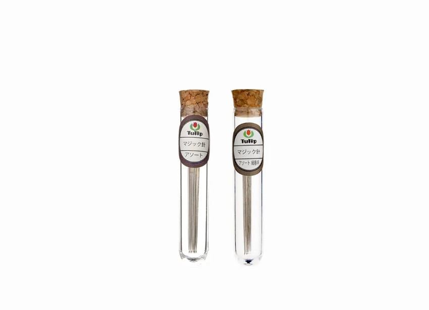 Two glass tubes with cork stoppers, each containing a small amount of liquid, are shown against a white background.