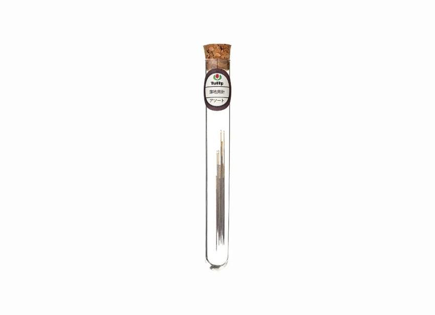 A clear glass tube containing a small amount of what appears to be a liquid or solid substance, with a cork stopper at the top.