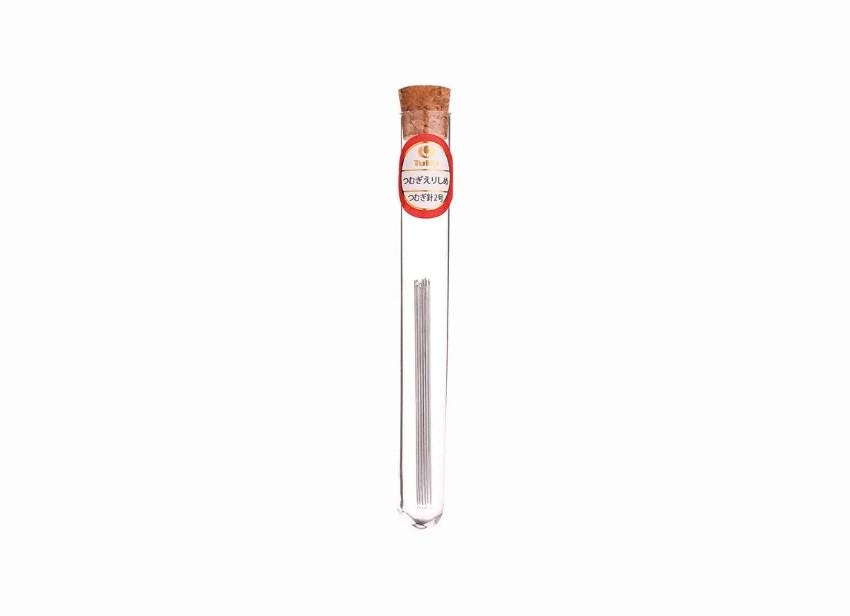 A clear glass tube containing a small object, with a red and white label on the top of the tube.