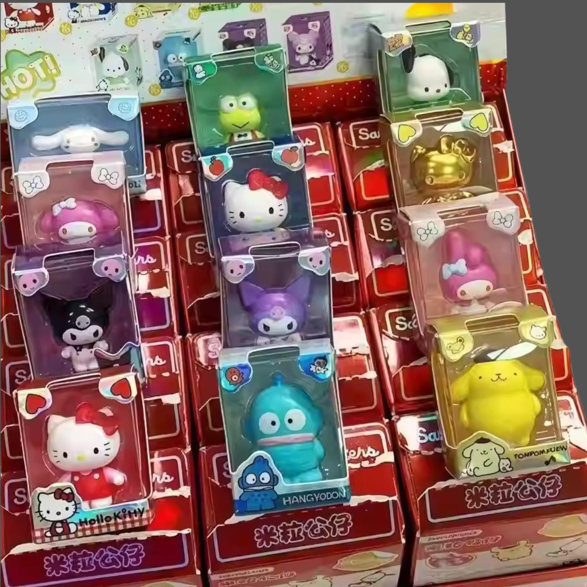 A collection of Hello Kitty figurines and packaging displayed on a shelf.