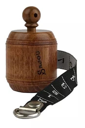 A wooden object with a black and white striped strap attached to it.