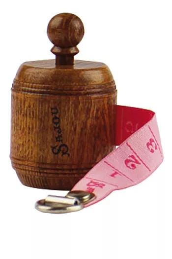 A wooden object with a wooden top and a pink measuring tape attached to it.