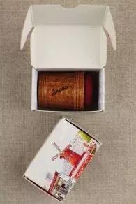 a wooden cup with a red interior, placed inside an open white box with a picture of a windmill on it.