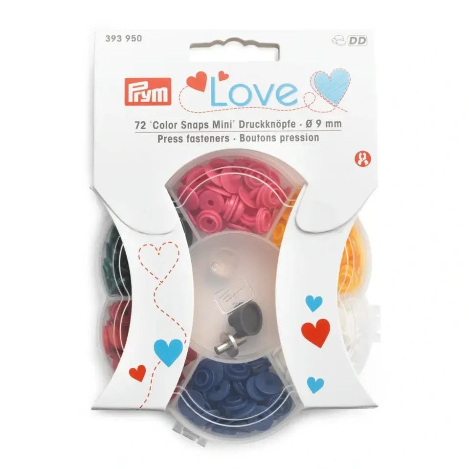 a package of Prym brand 72-Color Snaps Mini Druckknopf, which are small plastic buttons in various colors.