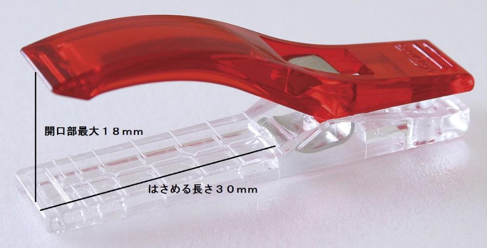 A red plastic tool with a clear plastic attachment, measuring 18 mm in length.