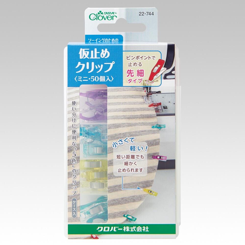 The image is a product packaging for a product called "Clover Clothespin". The packaging features a variety of colorful clothespins and a clear plastic window.
