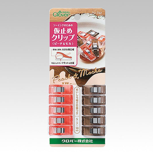 A product packaging for a pair of clover clips, with a picture of the clips and some text in Japanese.