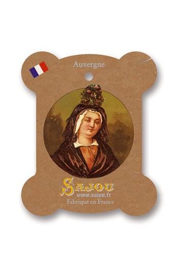a woman with a floral headpiece, wearing a brown robe and a white headdress.