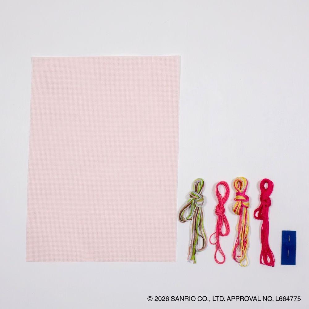 a pink square, four colorful strings tied in different knots, and a blue object, all arranged on a white background.
