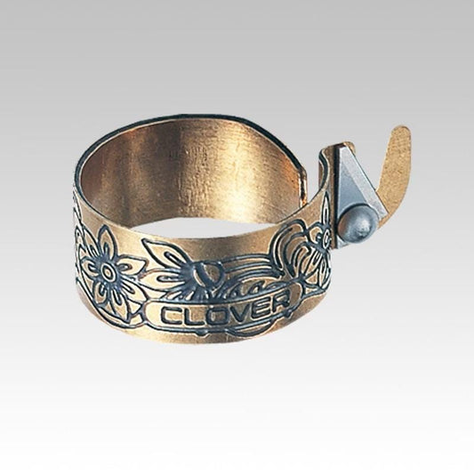 A decorative metal band with a floral pattern and the word "CLOVER" engraved on it.