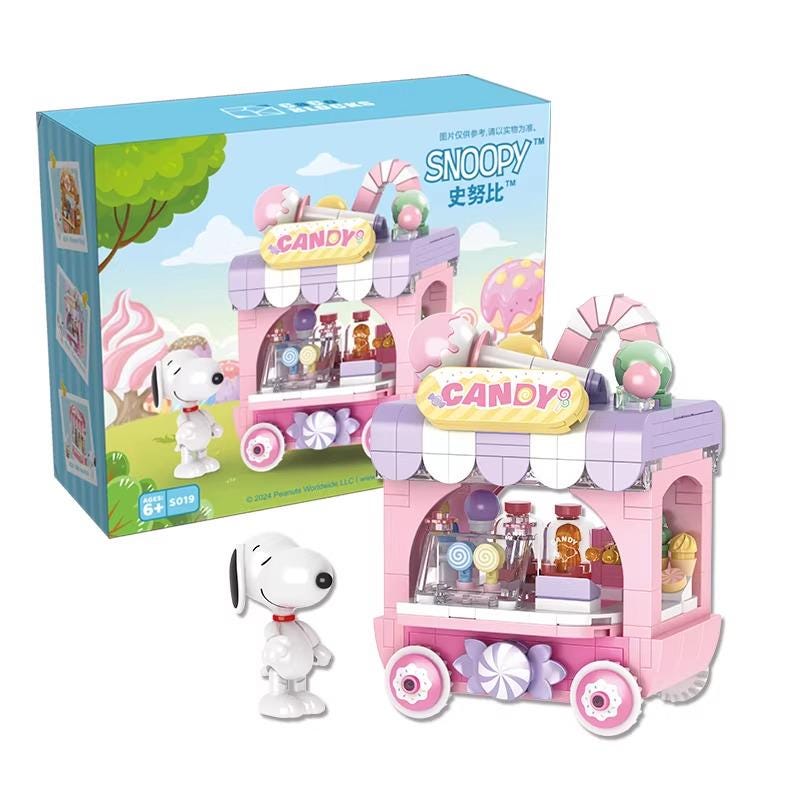 A toy vending machine with a Snoopy character and various candy items displayed on it.