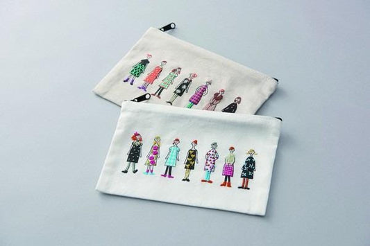 two white bags with colorful embroidered illustrations of women on them.