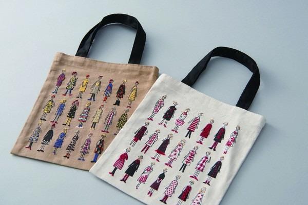 two tote bags with different designs on them, placed side by side on a light background.