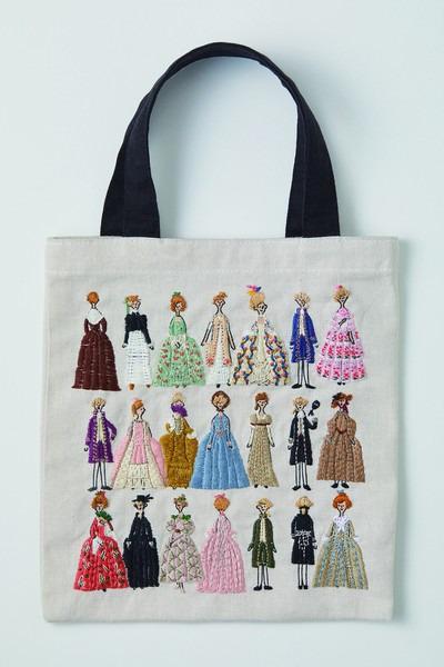 a tote bag with a collage of various colorful dresses and outfits, each depicting a different woman in a unique style.