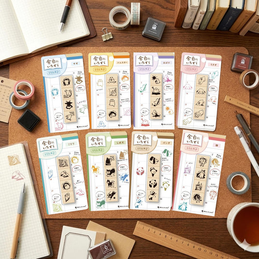 a variety of stationery items, including colorful stamp pads, pens, and other office supplies, arranged on a wooden surface.