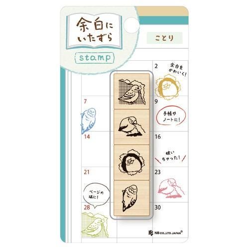 The image is a stamp with various bird illustrations, including a blue bird, a white bird, and a black bird. The stamp appears to be a creative and decorative item, possibly used for personal or artistic purposes.