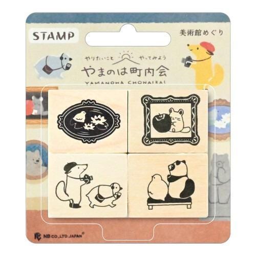 a set of four wooden stamps featuring various cartoon animal illustrations, including a dog, a cat, a bird, and a bear.