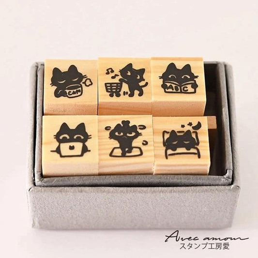 A set of six wooden stamps featuring various cat illustrations, including one with a cat holding a cup, another with a cat in a shopping cart, and a third with a cat sleeping.