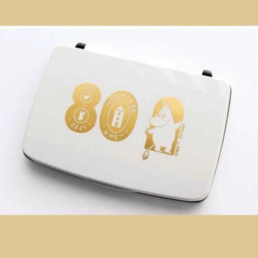 A white object with gold text and a gold Moomo character on it.