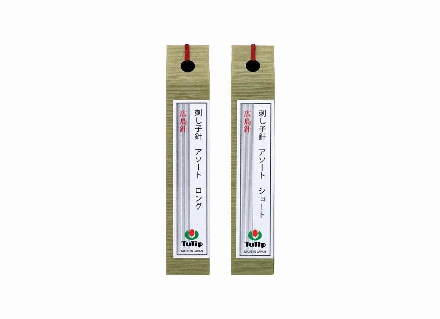 Two green tags with Japanese text and a logo, likely used for identification or organization purposes.