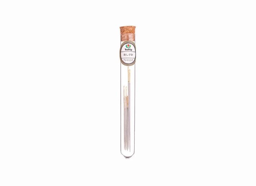 A clear glass tube containing multiple small metal objects, with a cork stopper at the top.